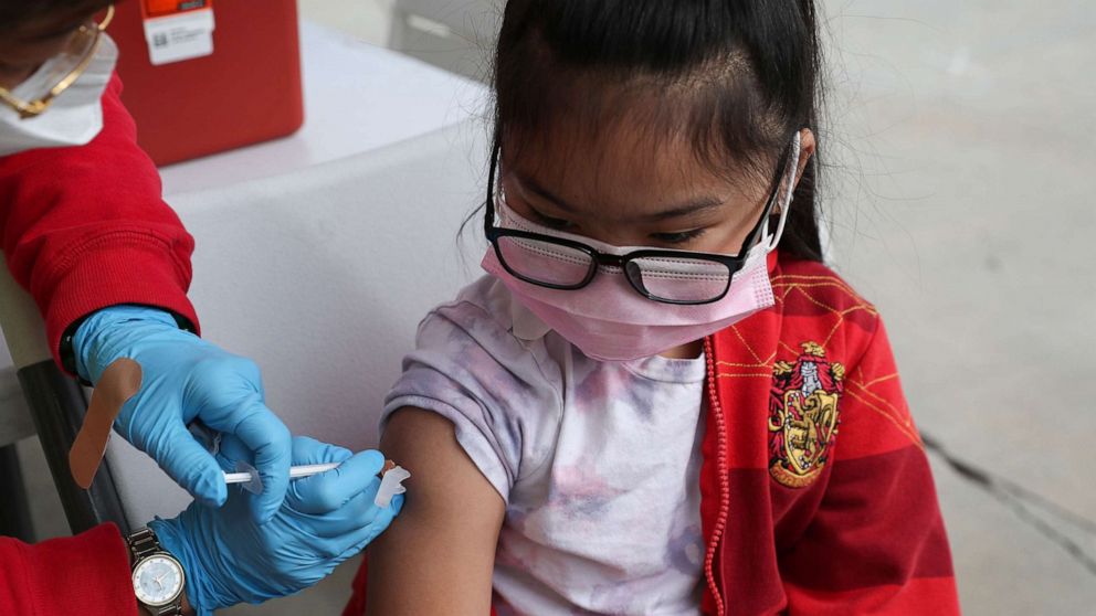 PHOTO: A 6-year-old girl receives a dose of the Pfizer BioNTech COVID-19 vaccine at a vaccination site at Lincoln Park Recreation Center in Los Angeles, Dec. 21, 2021.