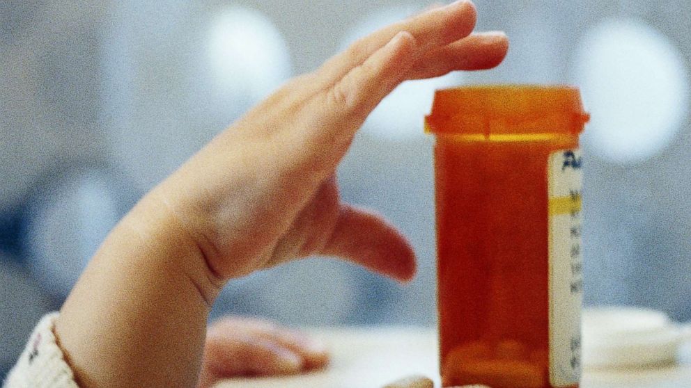 PHOTO: A child reaches for an open medicine bottle in an undated stock photo.