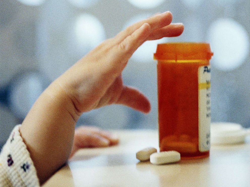 PHOTO: A child reaches for an open medicine bottle in an undated stock photo.