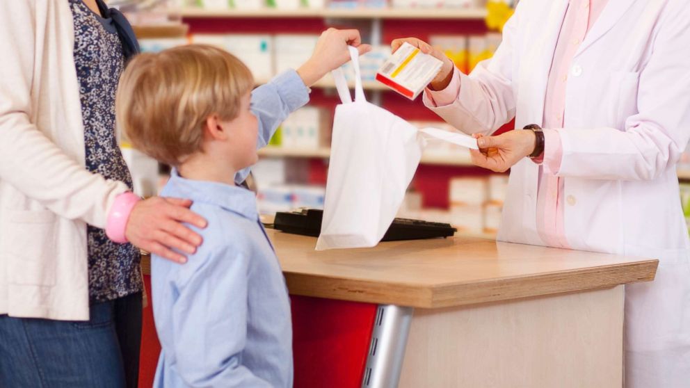 PHOTO: A mother picks up a prescription for her son in an undated stock photo.