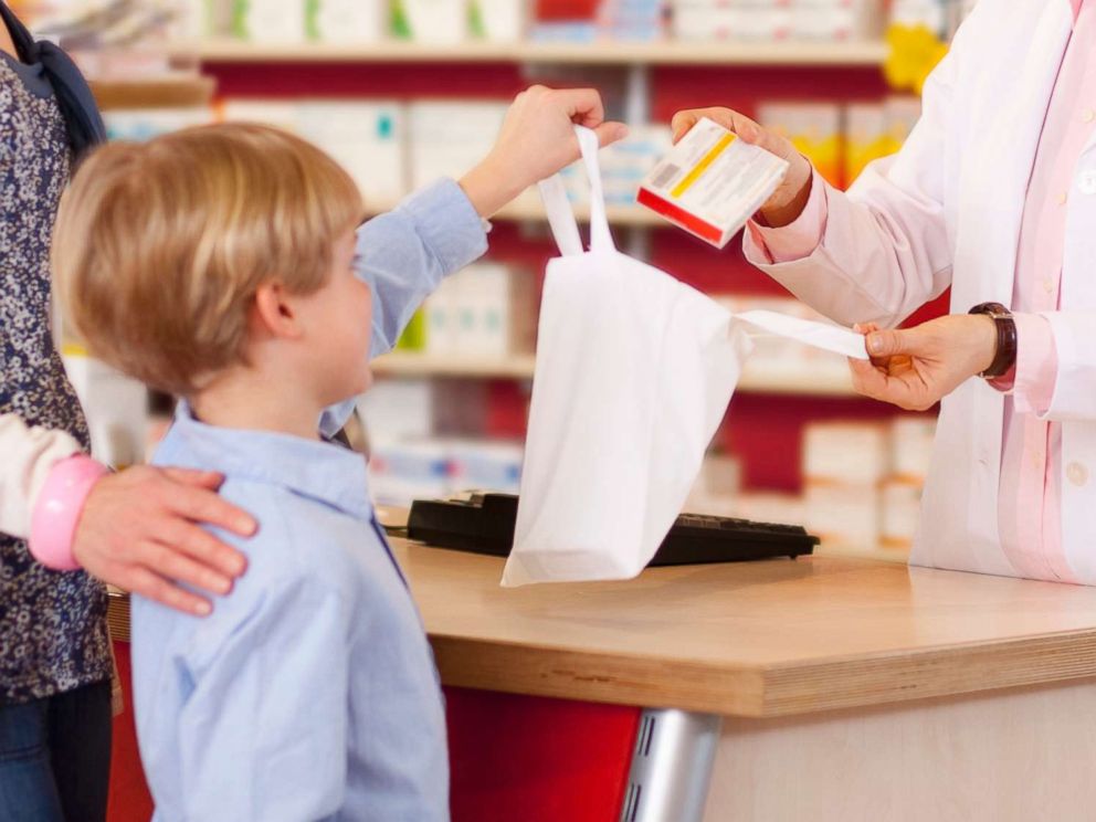 PHOTO: A mother picks up a prescription for her son in an undated stock photo. 