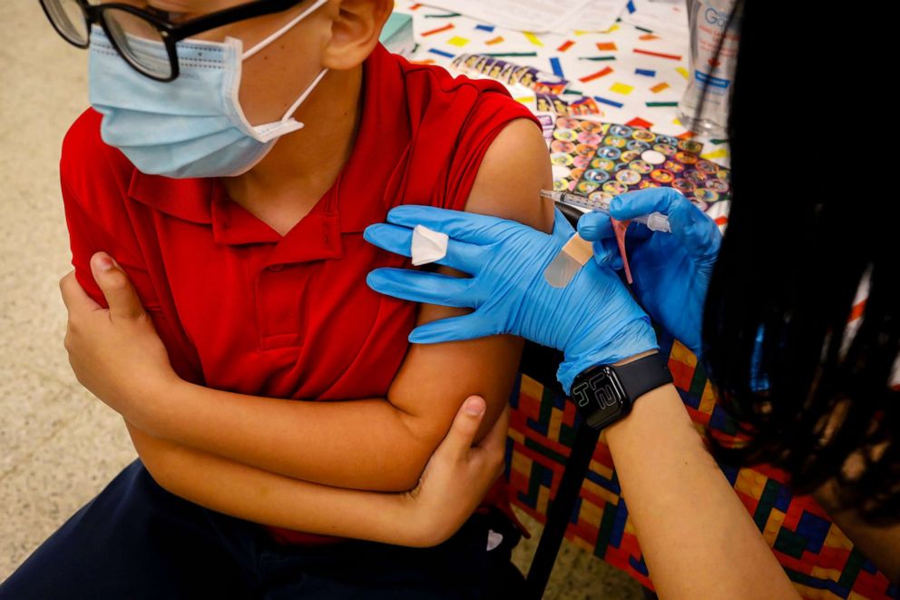 PHOTO: In this Nov. 22, 2021, file photo, a child receives a dose of the Pfizer-BioNTech COVID-19 vaccine at an elementary school vaccination site for children ages 5 to 11-year-old in Miami.