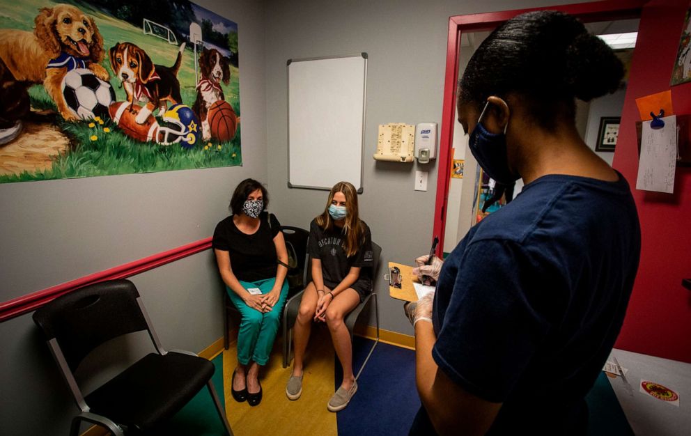 PHOTO: Middle school student Meredith Rogers, center, waits to receive her first coronavirus vaccination on Wednesday, May 12, 2021, in Decatur, Ga. 