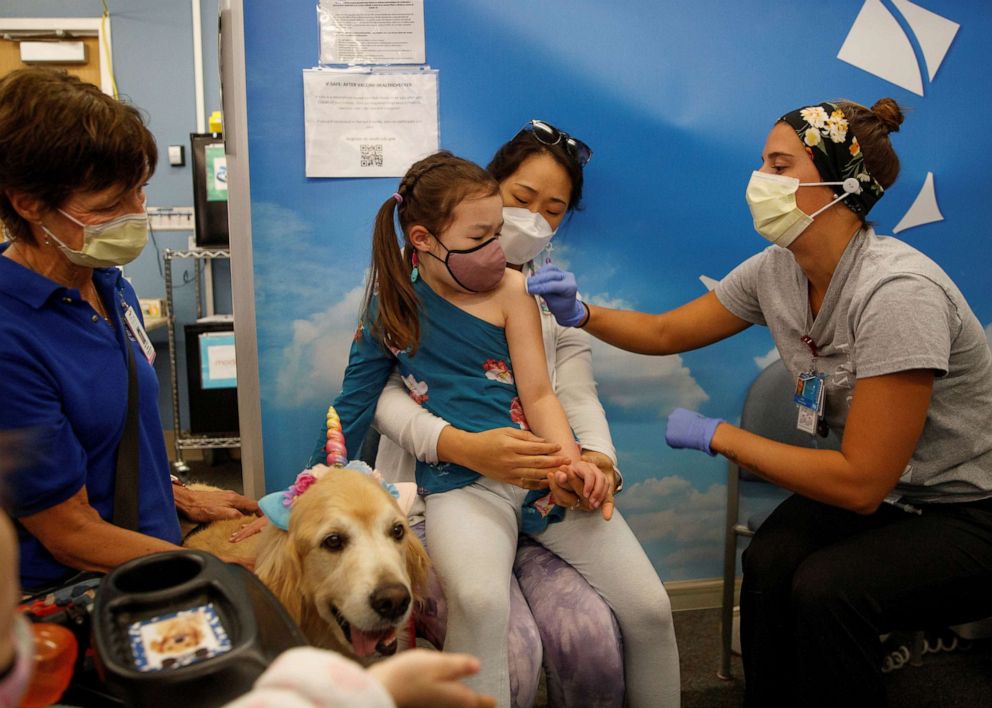 PHOTO: Six year-old Clara Bengle sits on her moms lap as she receives the Pfizer-BioNTech coronavirus vaccine at Rady's Children's hospital vaccination clinic in San Diego, Calif., Nov. 3, 2021.