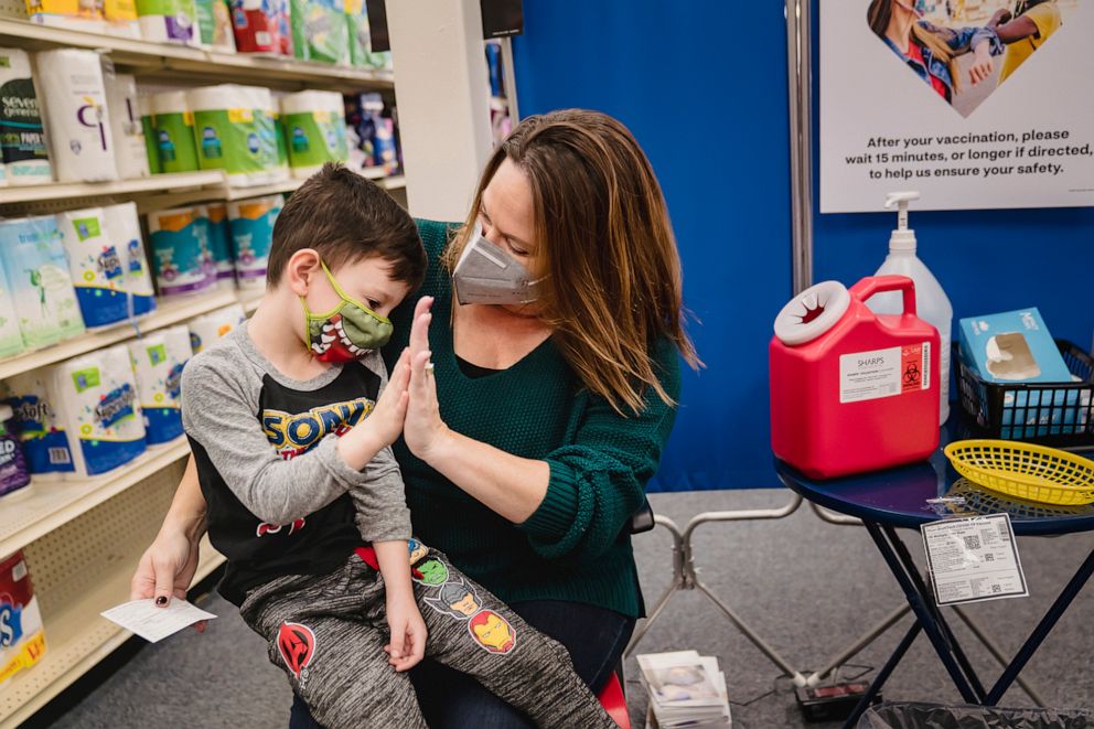 PHOTO: Lauren Rymer encourages her son Jack, 6, with a high-five while getting his first dose of a COVID-19 vaccine at a pharmacy in Lawrenceville, Ga., Nov. 15, 2021.
