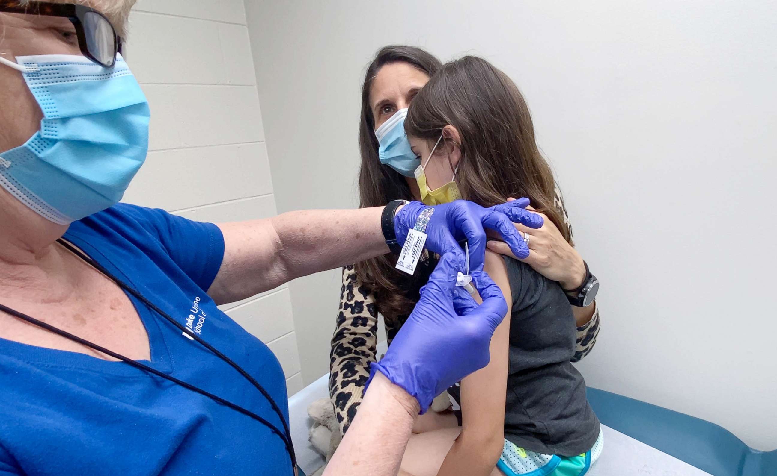 PHOTO: Alejandra Gerardo, 9, is held by her mother as she gets the second dose of the Pfizer Covid-19 vaccine during a clinical trial for children at Duke Health in Durham, N.C., April 12, 2021.