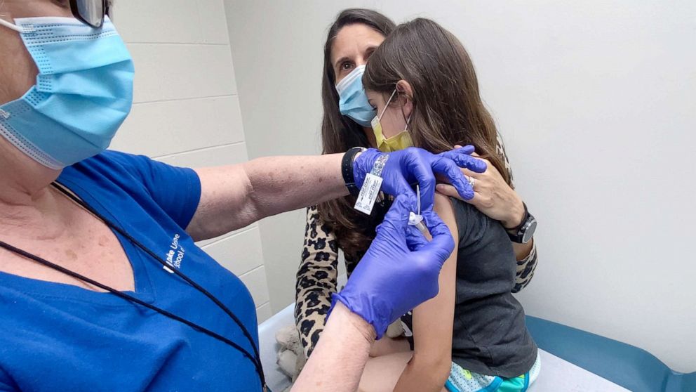 PHOTO: Alejandra Gerardo, 9, is held by her mother as she gets the second dose of the Pfizer Covid-19 vaccine during a clinical trial for children at Duke Health in Durham, N.C., April 12, 2021.
