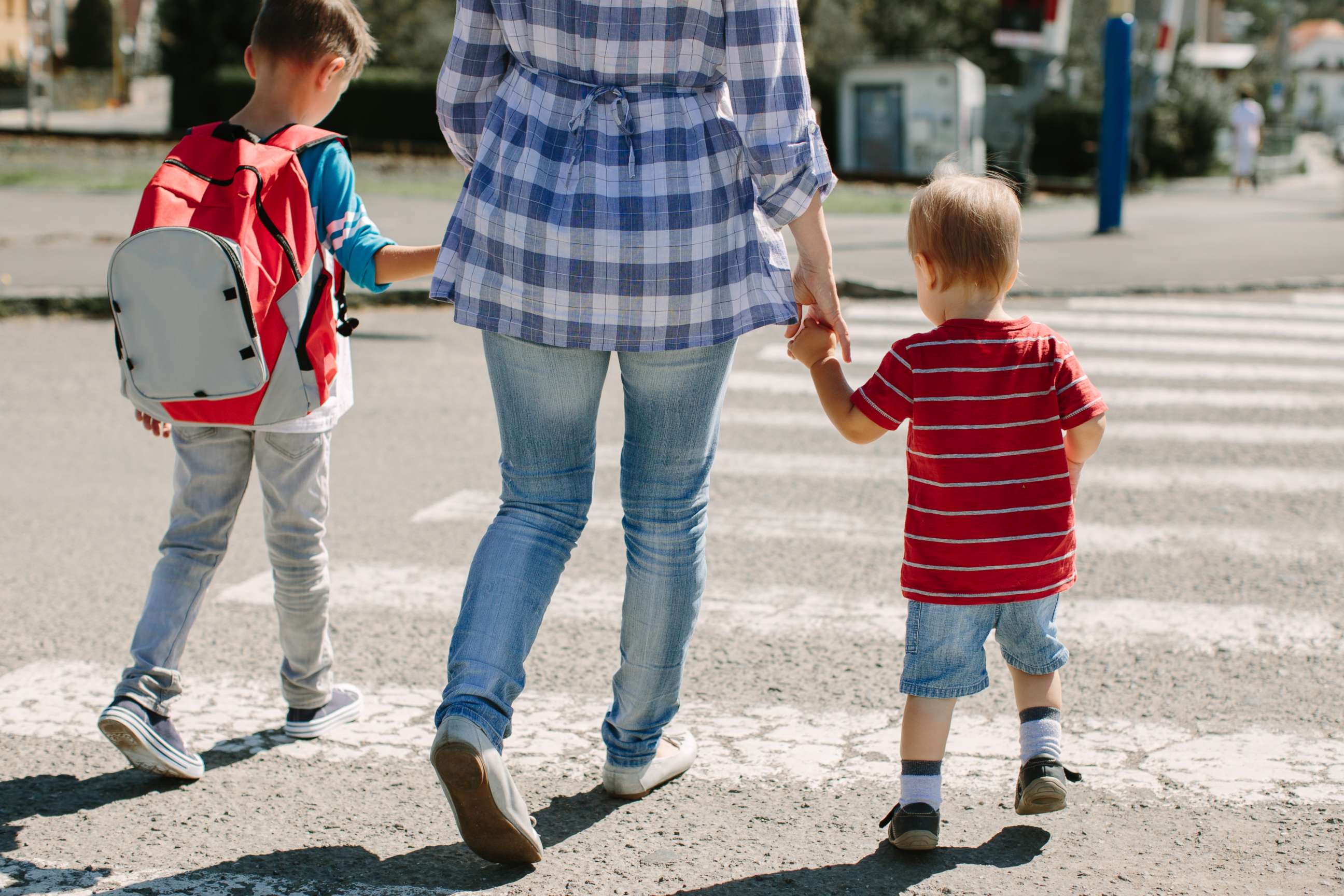 PHOTO: In this undated stock photo, a mother crosses a road with her children on way their way to school.