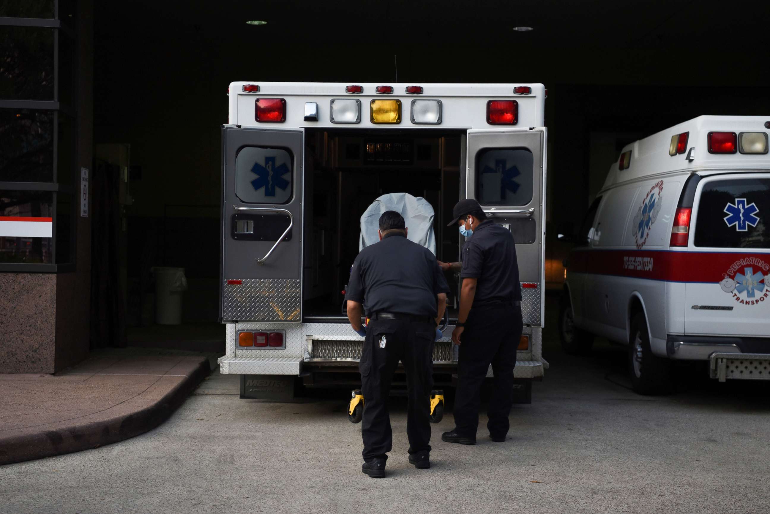 PHOTO: Healthcare workers place a stretcher inside an ambulance at Texas Children's Hospital as cases of the coronavirus disease (COVID-19) spike in Houston, Texas, July 8, 2020.  