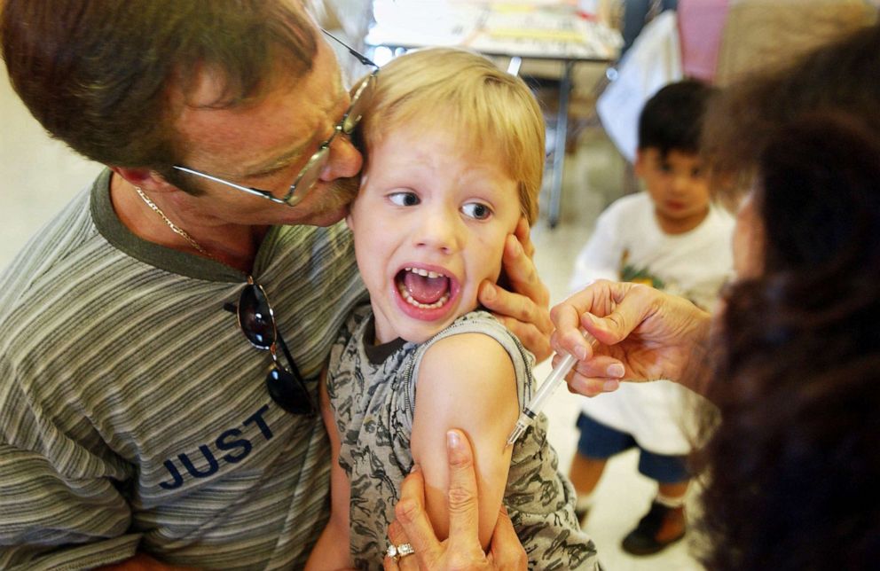 PHOTO: An incoming kindergartener reacts to a Measles, Mumps and Rubella vaccination as his father tries to comfort him in Santa Ana, Calif., Aug. 26, 2002.