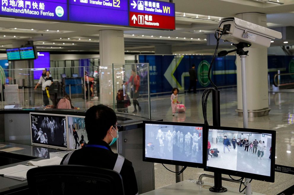 PHOTO: In this Jan. 4, 2020, file photo, a health surveillance officer monitors passengers arriving at the Hong Kong International airport in Hong Kong.