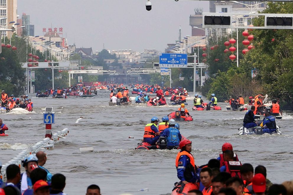 PHOTO: Rescuers use boats to evacuate people from a flooded area in Weihui in central China's Henan Province, July 26, 2021.