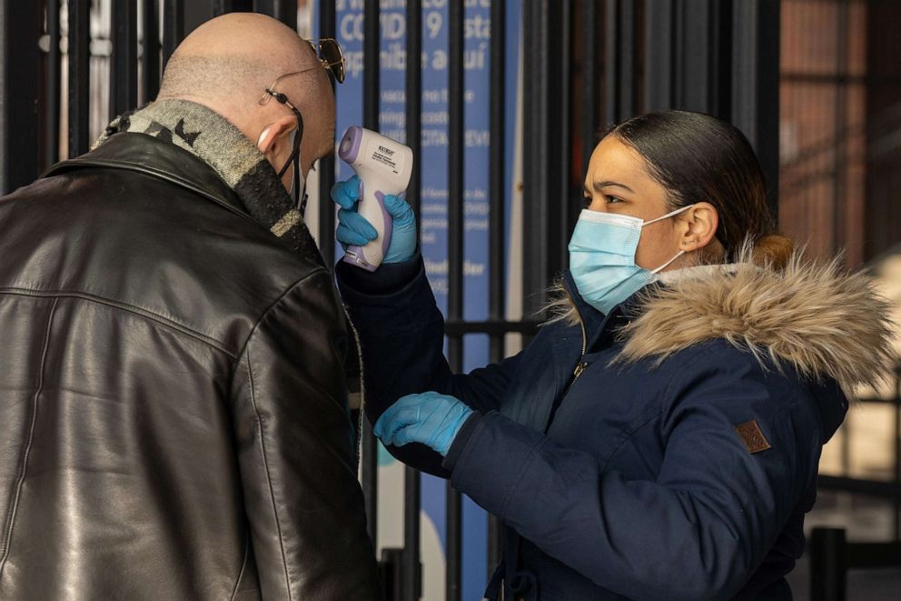 PHOTO: A person gets their temperature checked at the coronavirus (COVID-19) vaccination site at Citi Field, Feb. 10, 2021, in New York.