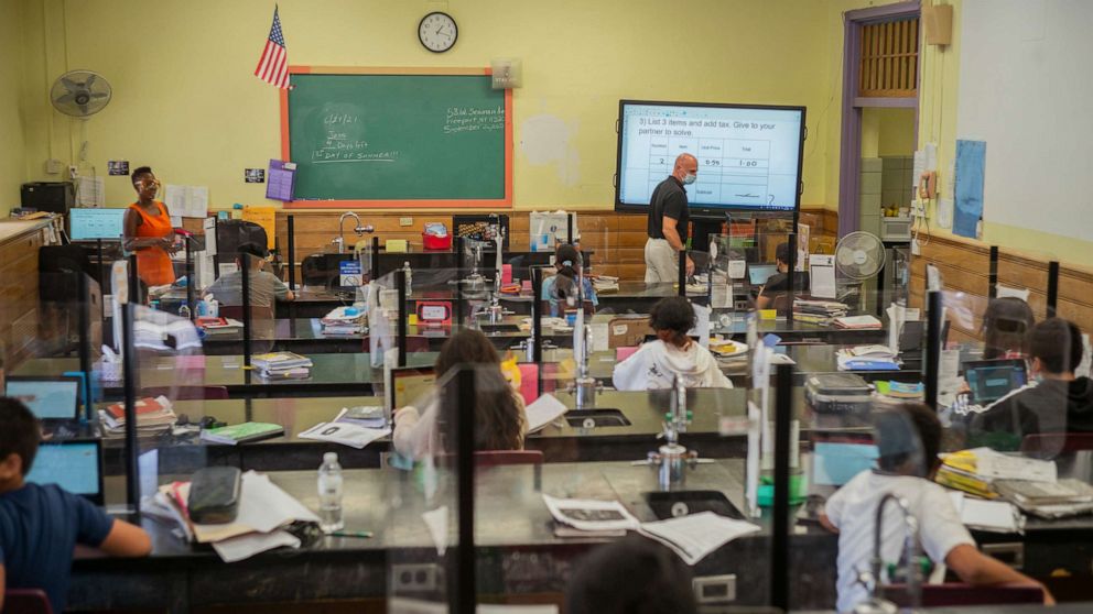 PHOTO: Fifth-grade students sit distanced from each other separated by plexiglass at Caroline G. Atkinson School in Freeport, N.Y., June 21, 2021.