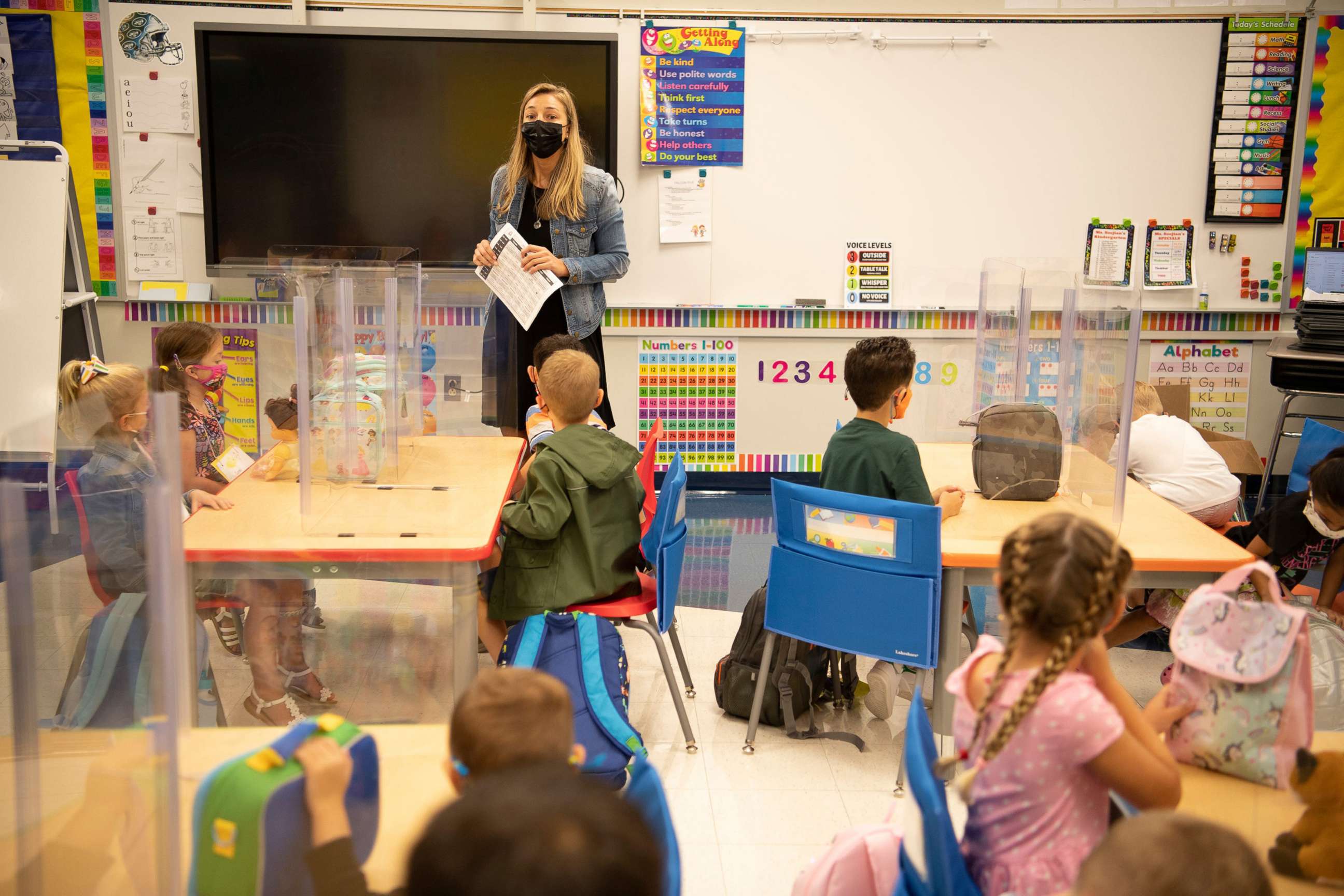 PHOTO: Kindergarten teacher Carly Soojian greets her classroom on their first day of school at James Fallon School in Wayne, N.J., Sept. 9, 2021.
