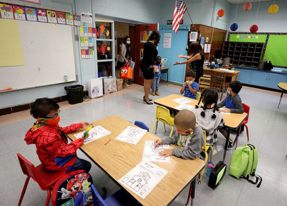 PHOTO: Leslie Dildy, the Principal of the Kahlil Gibran School, in Yonkers, N.Y., leads kindergartner Christian Price to his teacher Susan Salvi's classroom on the first day of school, Sept. 9, 2021.
