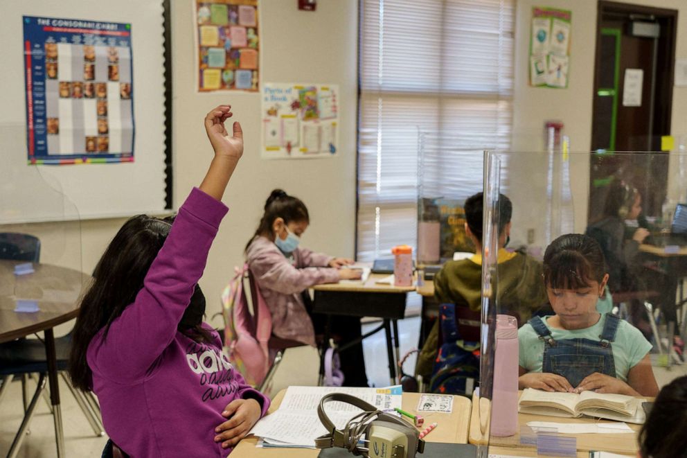 PHOTO: A student raises her hand during a third grade class at Highland Elementary School in Las Cruces, New Mexico, March 4, 2022.