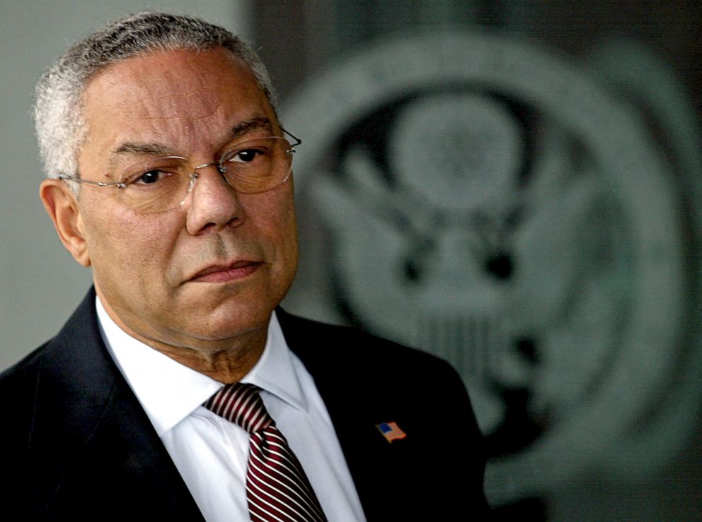 PHOTO: Former US Secretary of State Colin Powell listens to a question from a reporter outside the front doors of the State Department in Washington, D.C., Sept. 8, 2003.