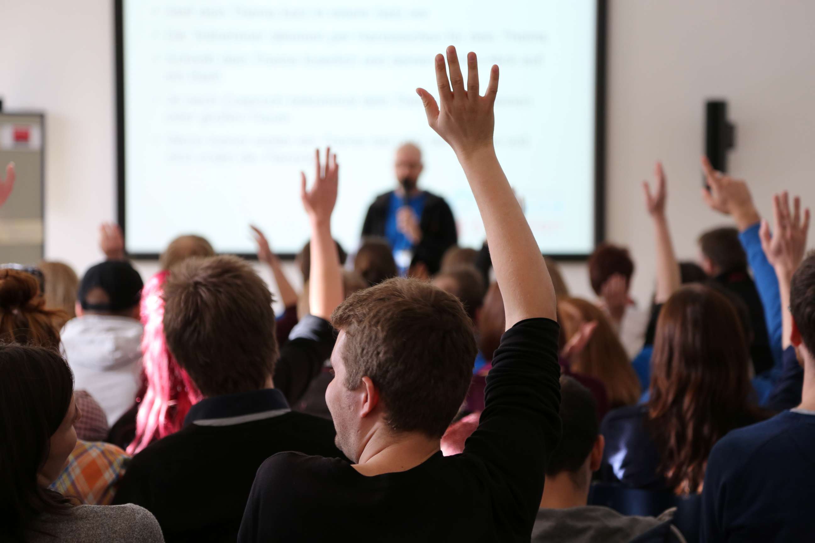 PHOTO: College students raise their hands in class in an undated stock photo.