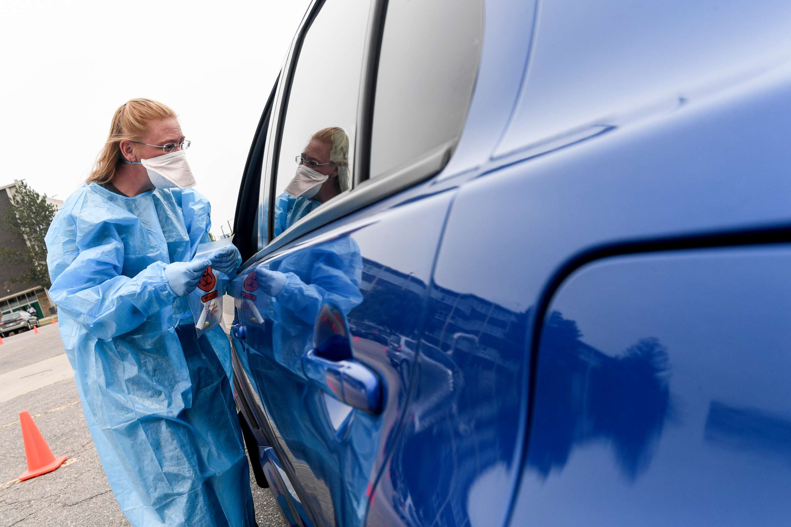 PHOTO: Kelly Cummings works at a COVID testing site in the parking lot of George Washington High School in Denver, Sept. 1, 2021.