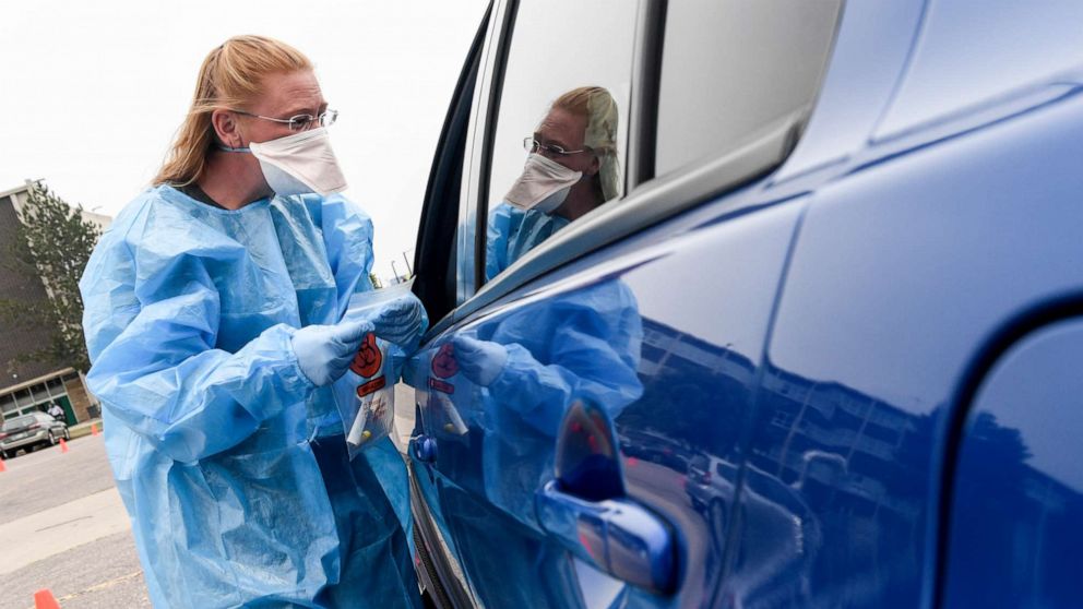 PHOTO: Kelly Cummings works at a COVID testing site in the parking lot of George Washington High School in Denver, Sept. 1, 2021.