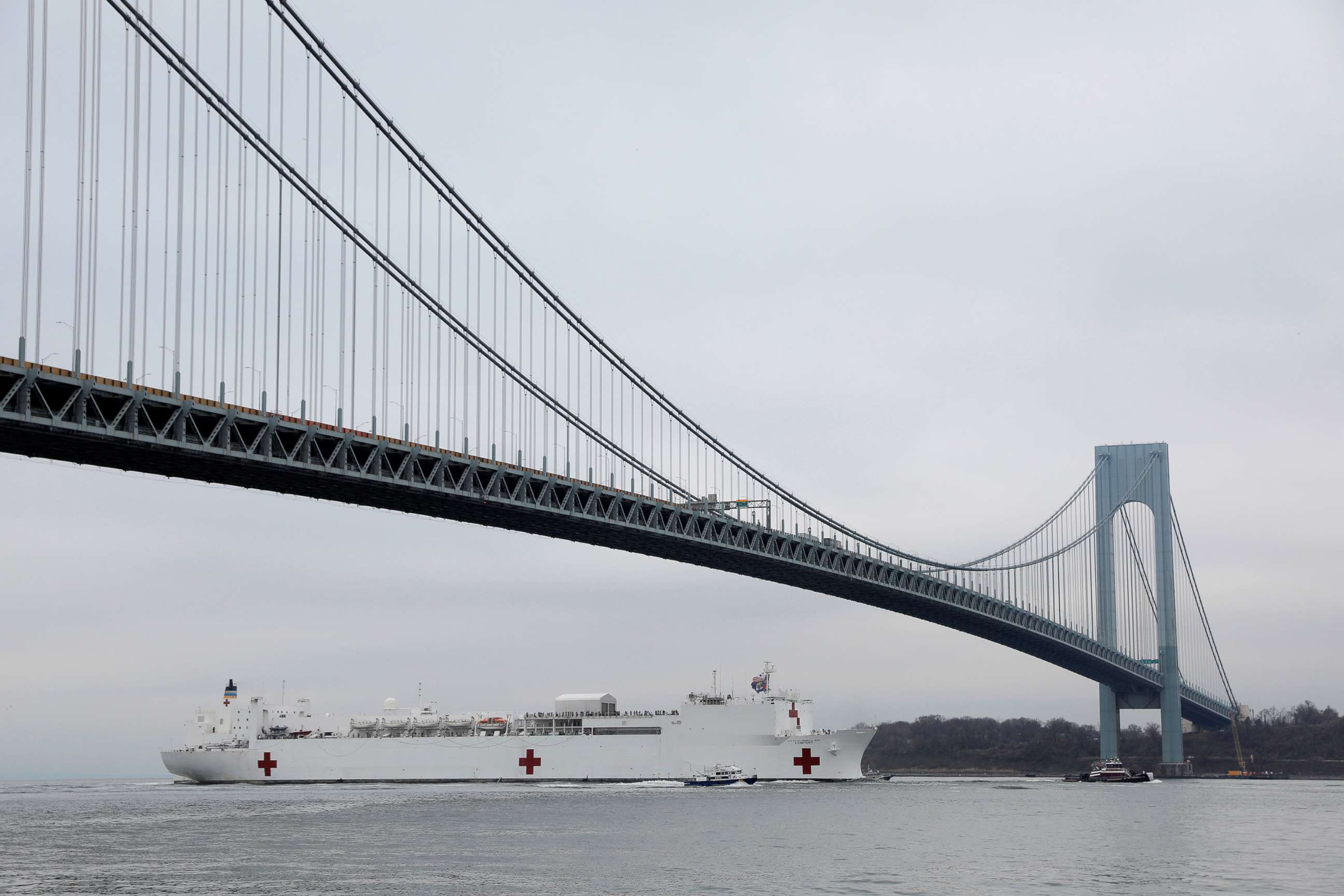 PHOTO: The USNS Comfort passes under the Verrazzano-Narrows Bridge as it enters New York Harbor during the outbreak of the coronavirus in New York, March 30, 2020. 