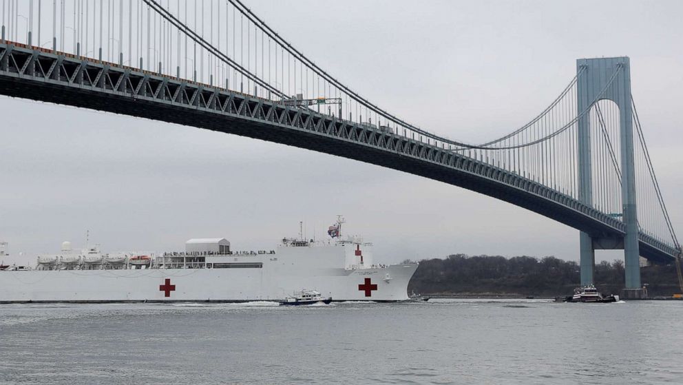 PHOTO: The USNS Comfort passes under the Verrazzano-Narrows Bridge as it enters New York Harbor during the outbreak of the coronavirus in New York, March 30, 2020. 