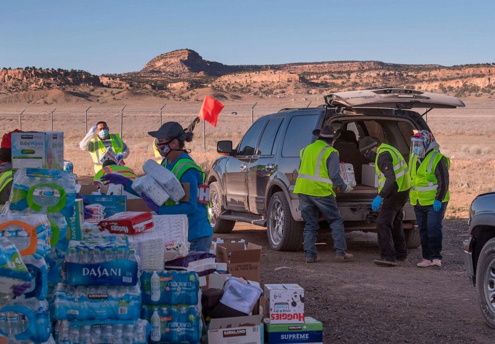 PHOTO: Native Americans of the Navajo Nation people, pick up supplies from a food bank set up at the Navajo Nation town of Casamero Lake in New Mexico on May 20, 2020.
