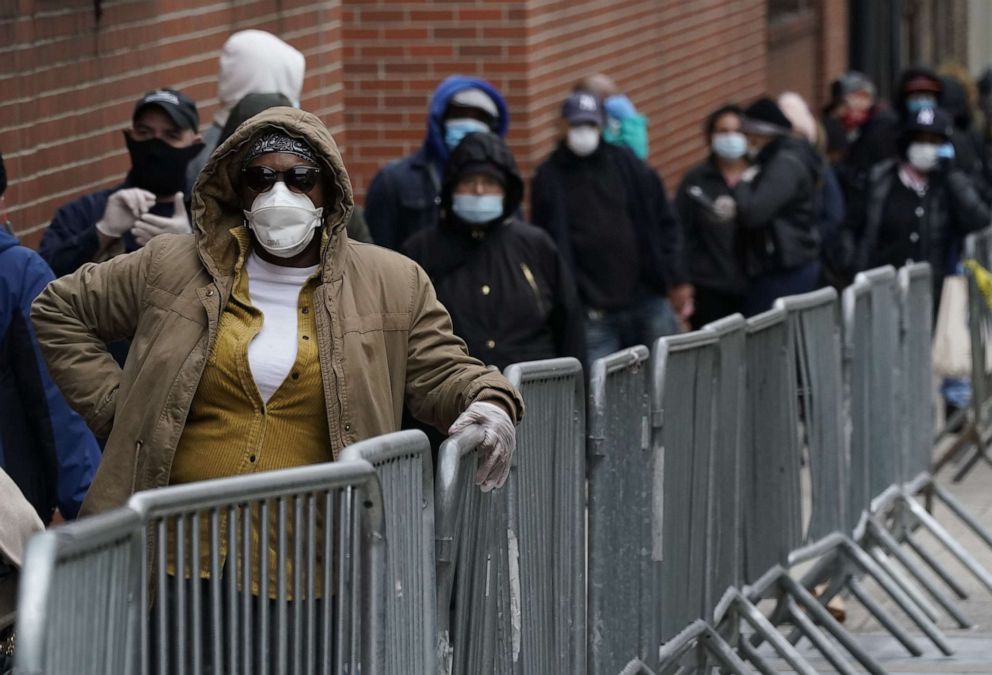 PHOTO: People wait in line for a coronavirus test at one of the new walk-in COVID-19 testing sites that opened at the located in the parking lot of NYC Health + Hospitals/Gotham Health Morrisania  in the Bronx Section of New York on April 20. 2020.