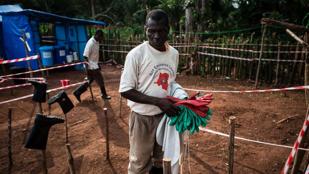 A health worker cleans equipment at an Ebola quarantine unit on June 11, 2017 in Muma, Democratic Republic of Congo.