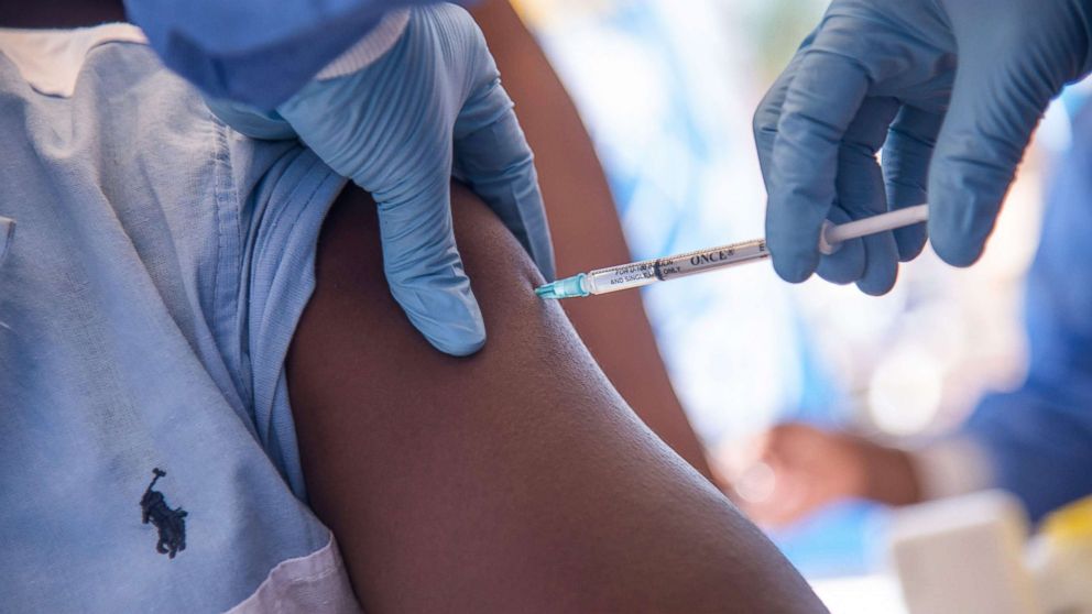  Nurses working with the World Health Organization (WHO) administer the Ebola vaccine to a local doctor at the town all of Mbandaka, Democratic Republic of Congo, May 21, 2018 during the launch of the Ebola vaccination campaign. 