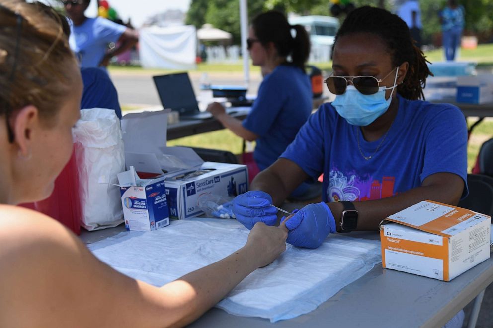 PHOTO: A woman receives a COVID-19 antibody test during the Juneteenth Festival on June 19, 2021, in Tulsa, Okla.