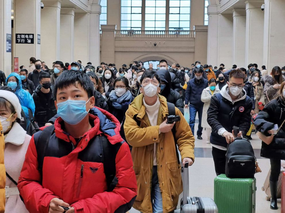 PHOTO: People wear face masks as they wait at Hankou Railway Station on January 22, 2020 in Wuhan, China.