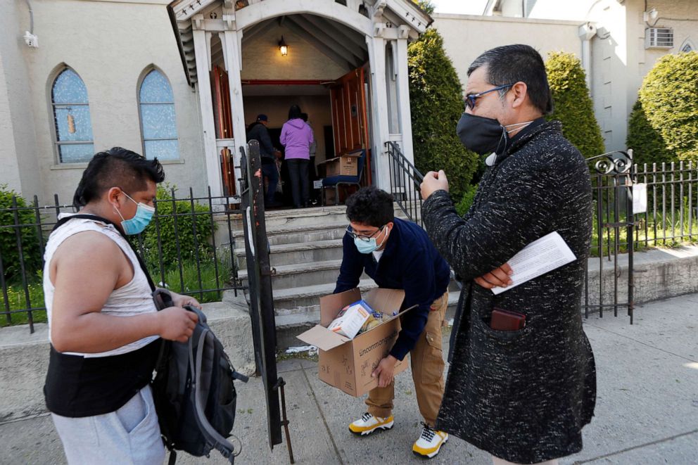 PHOTO: Edgar Chun who was laid off from his job in the wake of the coronavirus outbreak, appeals to Pastor Juan Carlos Ruiz for emergency food aid in front of Lutheran Church of the Good Shepherd, in the Brooklyn borough of New York, May 12, 2020.