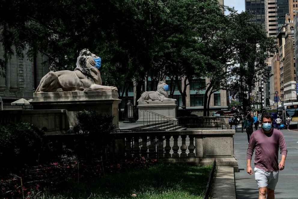 PHOTO: Patience and Fortitude, the marble lion statues at the entrance to the New York Public Library, are adorned with face masks on June 30, 2020, in New York.