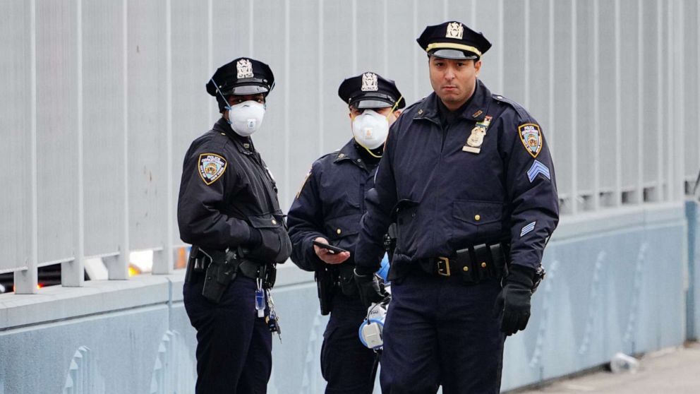 PHOTO: NYPD officers prepare to disperse people who gathered to check out the USNS Comfort on March 31, 2020, in New York.