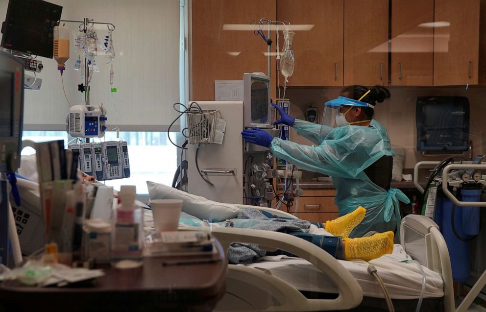 PHOTO: A healthcare worker in protective gear treats a coronavirus disease patient at the El Centro Regional Medical Center in El Centro, Calif., May 27, 2020.