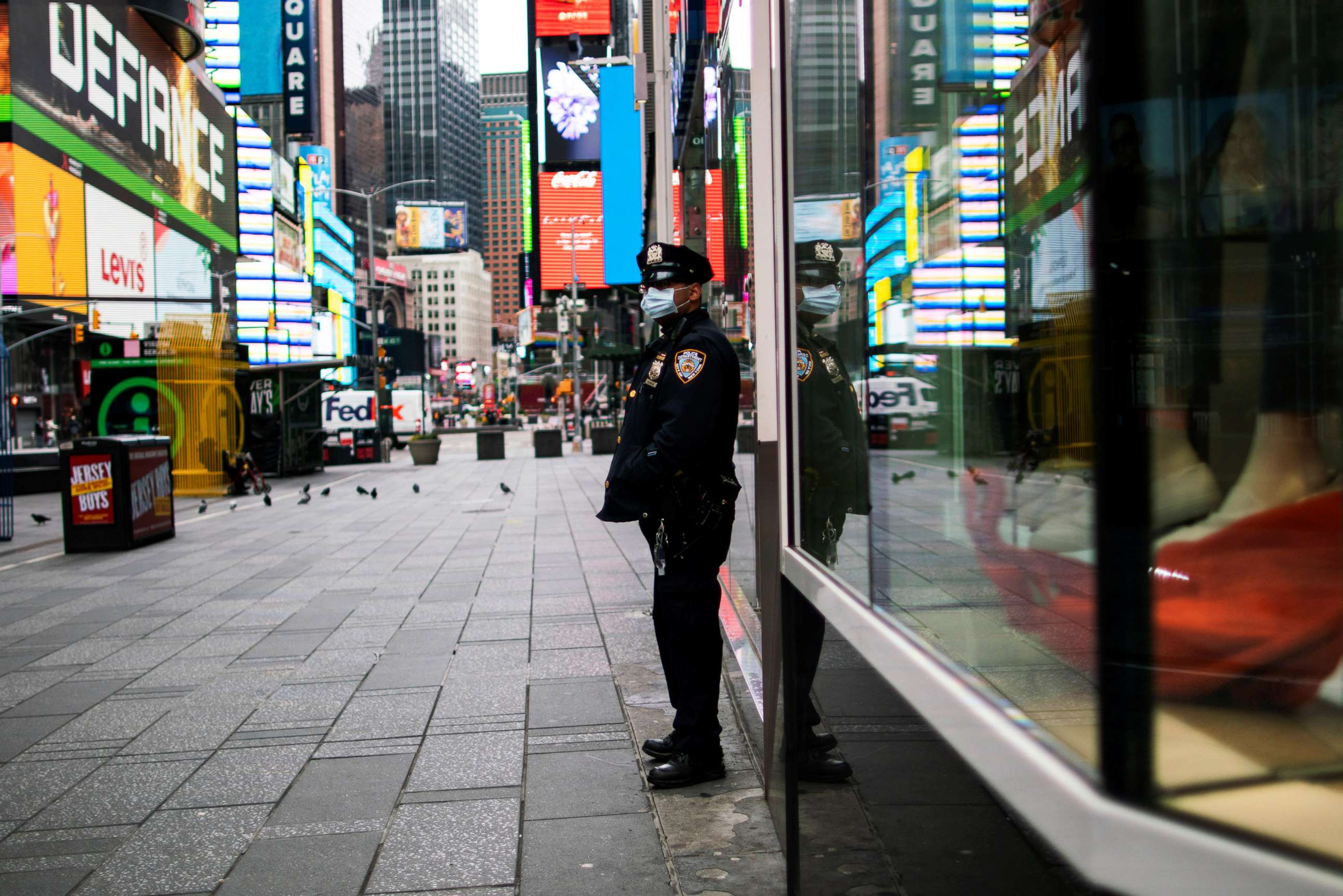 PHOTO: A New York Police officer stands guard in an almost empty Times Square during the outbreak of the coronavirus disease in New York, March 31, 2020.