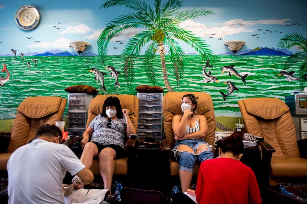 PHOTO: Manager David Grady and owner Mimi Nguyen do a mother and daughter's nails at AZ Nails Spa 101 in Peoria, Ariz., May 8, 2020.