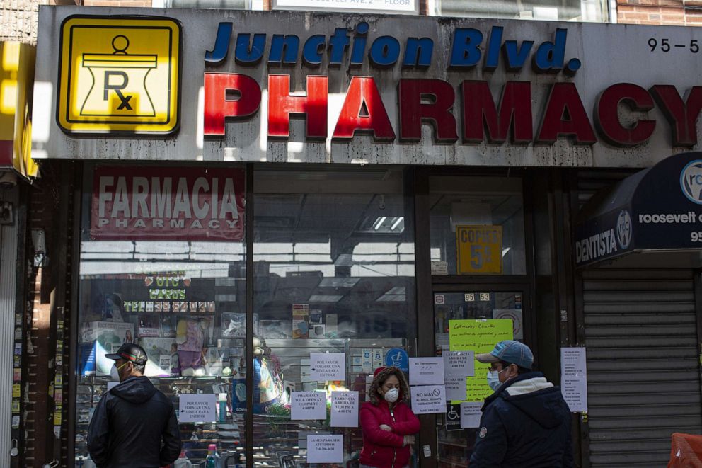 PHOTO: People wait in line outside a pharmacy on April 07, 2020, in the Queens borough of New York.