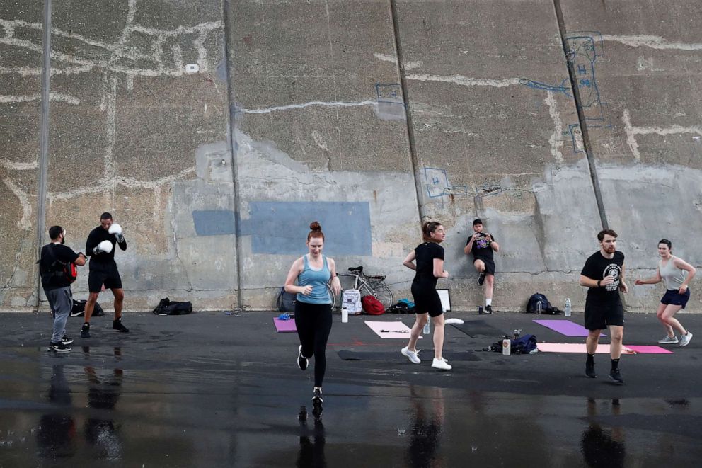 PHOTO: People exercise under the Triborough Bridge in the Queens borough of New York, Aug. 19, 2020.