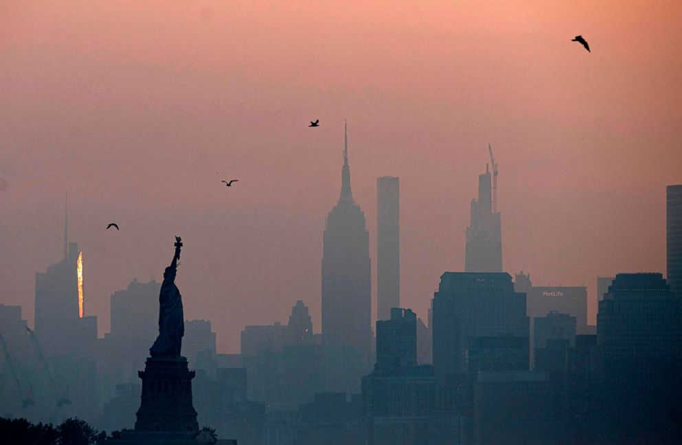 PHOTO: The Statue of Liberty is seen next to the Manhattan skyline during sunrise on July 9, 2020, in New York.