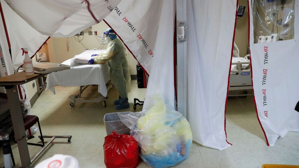 PHOTO: A hospital housekeeper at Roseland Community Hospital disinfects the room where a coronavirus disease positive patient died on the South Side of Chicago, Dec. 1, 2020.