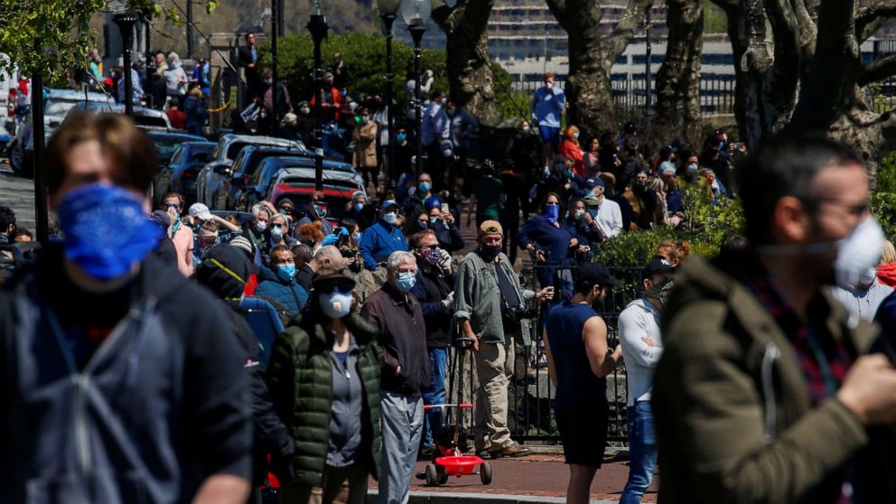 PHOTO: People try to keep social distance as they watch the Navy Blue Angels and Air Force Thunderbirds demonstration teams participating in a midday flyover of New York  as part of the "America Strong" tour of U.S. cities, April 28, 2020.