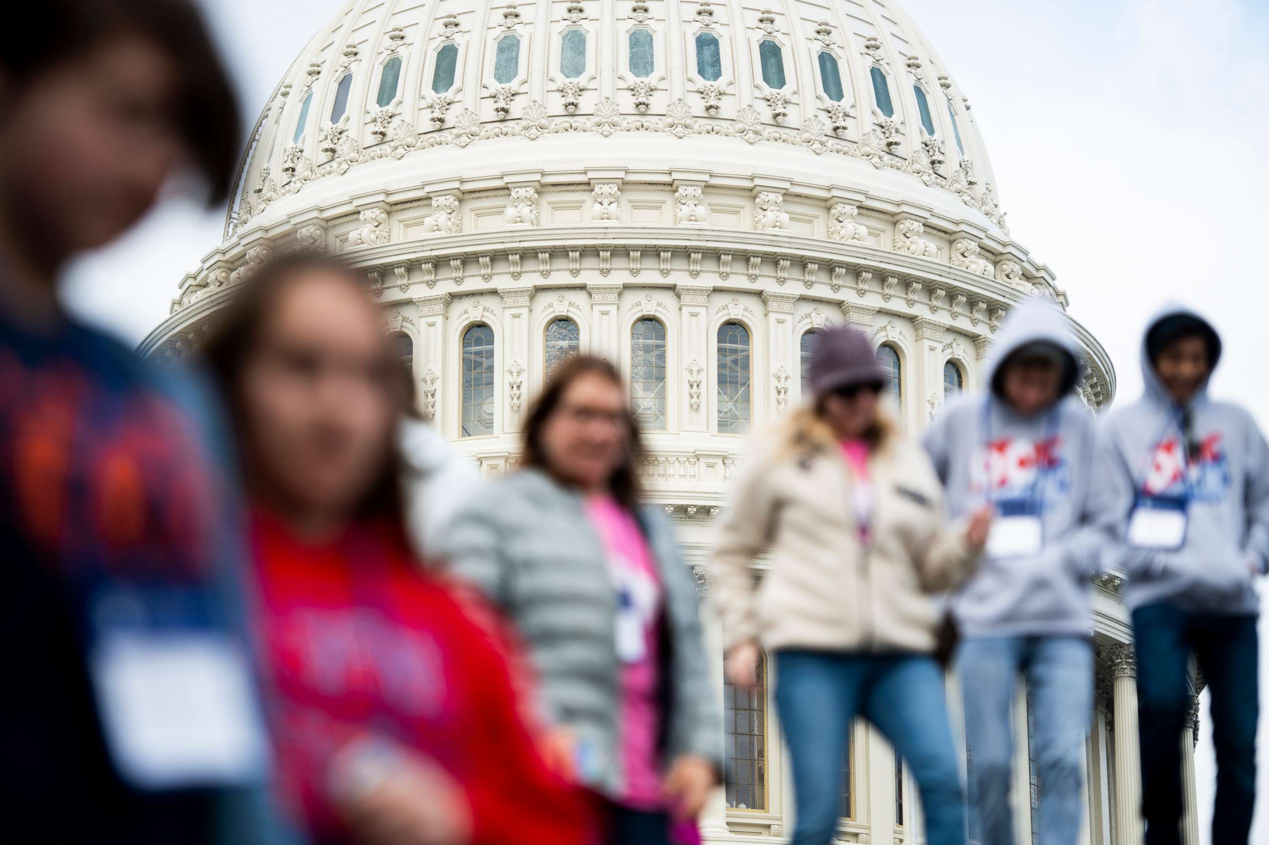PHOTO: Tourists walk in front of the U.S. Capitol dome down the steps to the Capitol Visitor Center on Thursday, March 12, 2020.