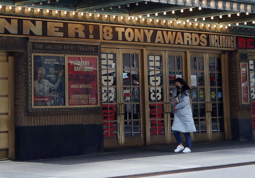 PHOTO: A pedestrian walks past the closed Broadway show Hadestown on April 02, 2020, in New York.