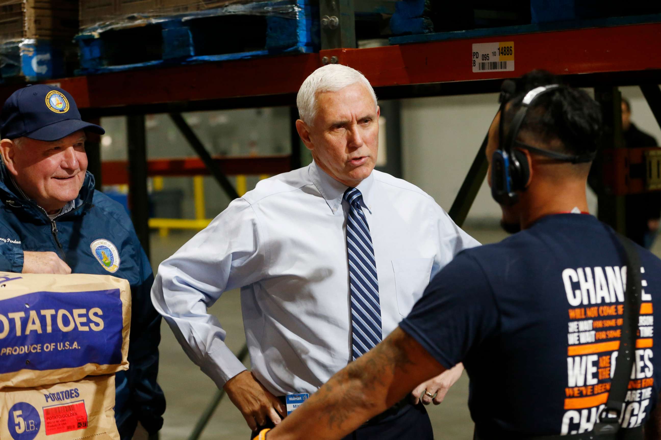 PHOTO: Vice President Mike Pence talks with order picker Bin Sam as Agriculture Secretary Sonny Purdue listens during a tour of a Walmart Distribution Center, April 1, 2020, in Gordonsville, Va.