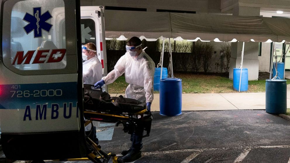 PHOTO: A stretcher is loaded back into an ambulance after EMTs dropped off a patient at a newly opened field hospital operated by Care New England to handle a surge of COVID-19 patients in Cranston, R.I, Dec. 1, 2020.