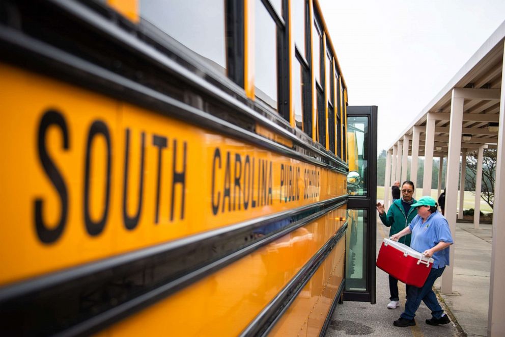 PHOTO: Kershaw County school district staff load buses with food to be delivered to students along their respective routes, March 18, 2020, during the coronavirus pandemic in South Carolina.