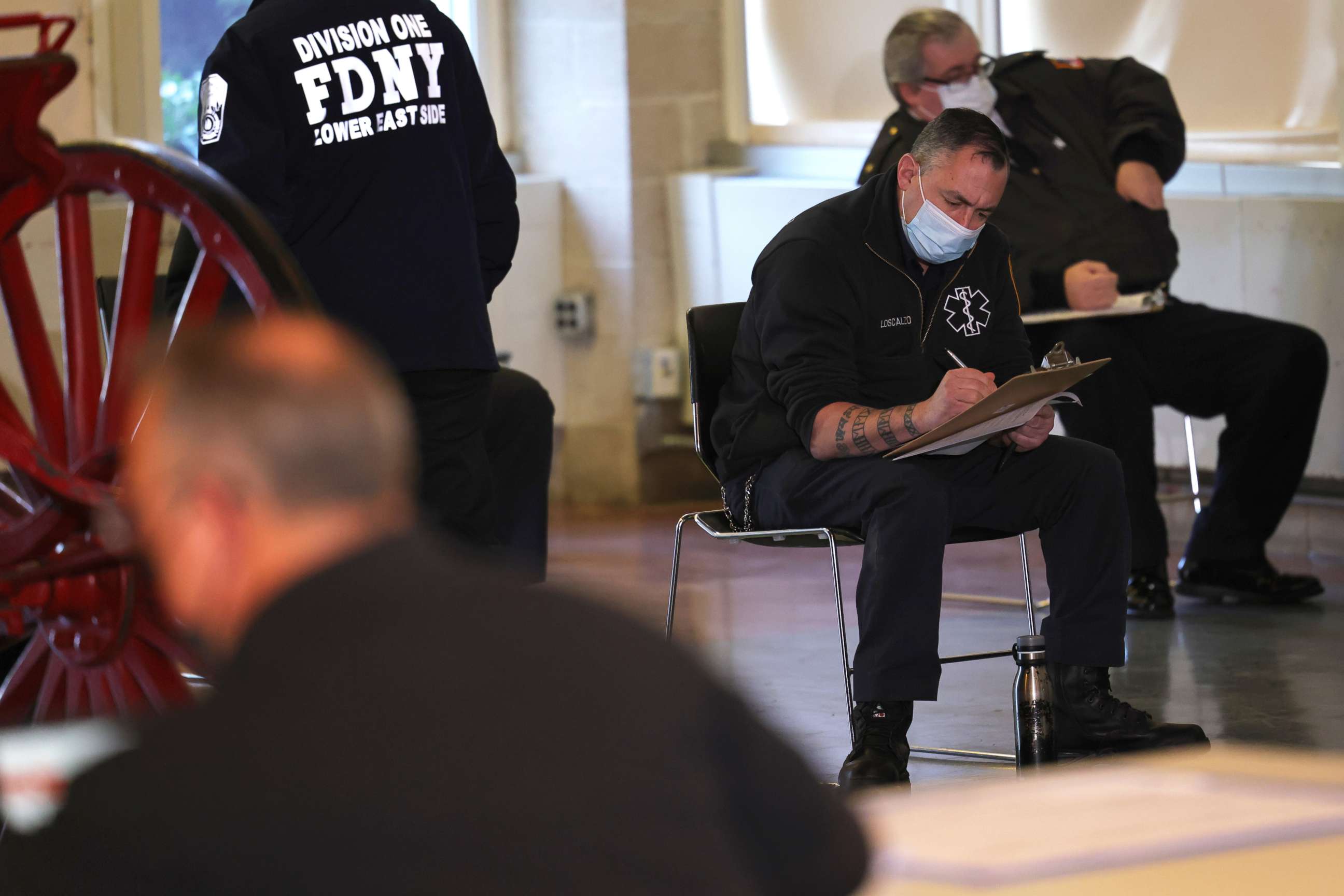 PHOTO: In this Dec. 23, 2020 file photo members of the Fire Department of New York Emergency Medical Services fill out forms as they prepare to receive their coronavirus vaccine in New York.